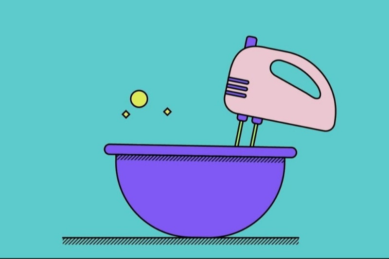 Ein Mixer rührt in einer Schüssel um